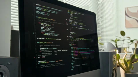 Computer Monitor Displaying Colourful Programming Code and Two Desktop Speakers Stock Footage 329609589