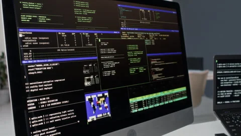 Computer Monitor Displaying Program Code Running on Black Screen in Office 스톡 동영상 330124113