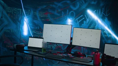 Computer Monitors and Laptops with Blank Screens on Table in Hacker Workspace Stock Footage 327632988