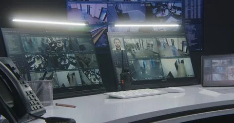 Computer monitors and tablet showing video footage of surveillance cameras Foto stock