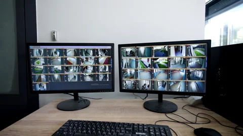 Computer monitors display live security camera streams Stock Footage 337716702