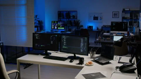 Computer Monitors Displaying Code in Empty Cybersecurity Office Stock Footage 347288908