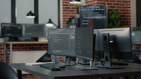 Computer monitors displaying parsing code in empty it agency office and Stock Footage 168234174