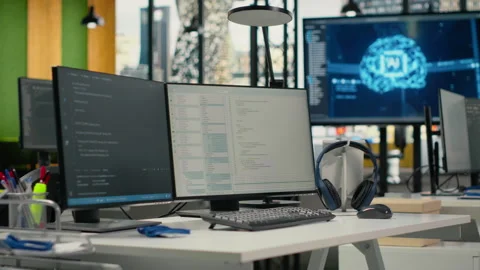 Computer monitors in empty startup workspace with cloud computing AI resources Stock Footage 323029779