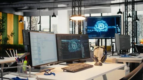 Computer monitors in empty startup workspace with cloud computing AI resources Stock-Fotos