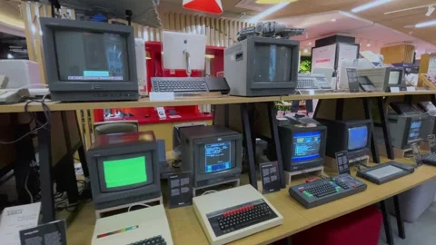 Computer monitors with keyboards displaying games in exhibit Stock Footage 270170000