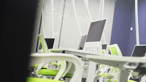 Computer monitors on tables in school IT classroom Video stock 236176125