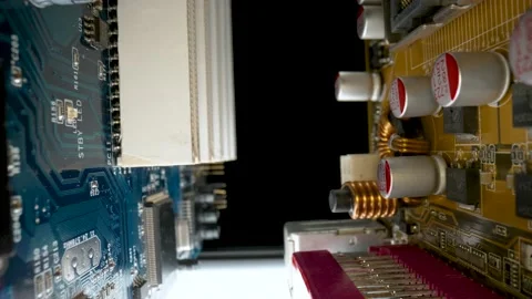 Computer motherboard microcircuit with chips, RAM slots, induction coils and Stock Footage 182399698