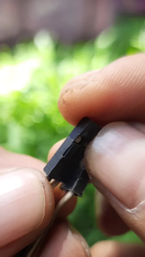 Computer motherboard power and reset switch connectors, hands holding elect.. Stock Footage 342628485