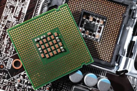 Computer motherboard with processor microchip as background, top view. Electr Stock Photos