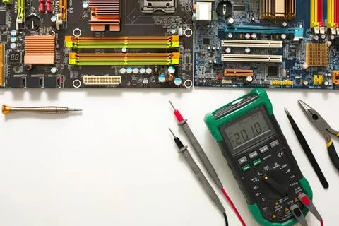 Computer motherboard with tools and electronic components Stock Photos