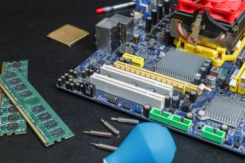 Computer motherboard two RAM slots, a processor with a cooler on the table 写真素材