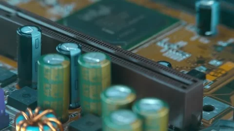 On the computer motherboard we see many capacitors, coils and a processor Stock Footage 259786887