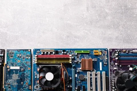 Computer motherboards on light grey table, flat lay with space for text. Elec Foto stock
