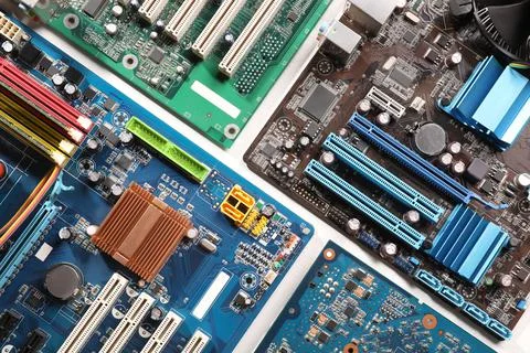 Computer motherboards on white table, flat lay. Electronic device Stock Photos