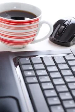 Computer mouse and coffee cup Stock Photos