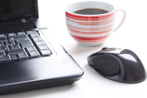 Computer mouse and coffee cup Stock Photos