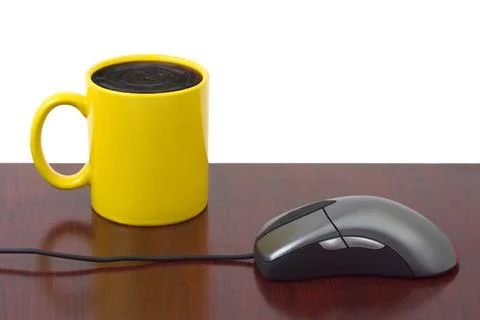 Computer mouse and coffee cup Computer mouse and coffee cup isolated on wh... Stock Photos