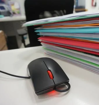 Computer mouse and document folder Stock Photos