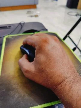 A computer mouse in and hand Stock Photos