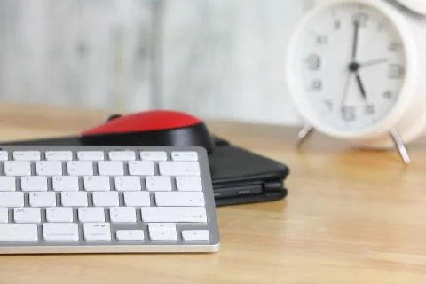 Computer mouse and keyboard on a table. Wooden background. Work place. Finance. Stock Photos