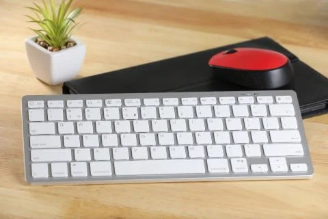 Computer mouse and keyboard on a table. Wooden background. Work place. Finance. Stock Photos