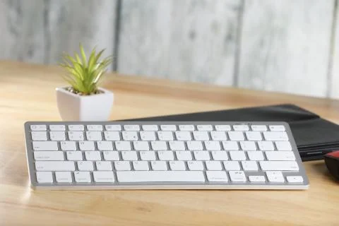 Computer mouse and keyboard on a table. Wooden background. Work place. Finance. Stock Photos
