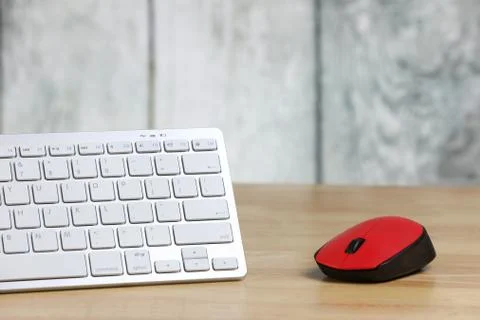 Computer mouse and keyboard on a table. Wooden background. Work place. Finance. Stock Photos