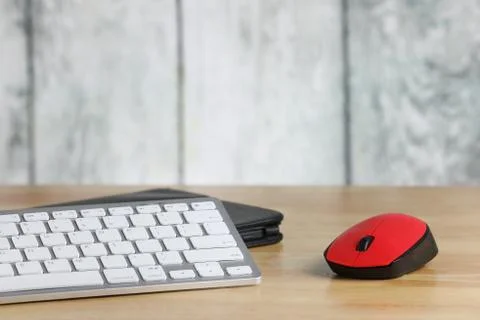 Computer mouse and keyboard on a table. Wooden background. Work place. Finance. Stock Photos