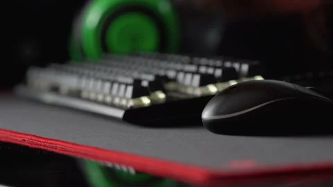 Computer mouse and keyboard with white backlight on the background of headphones Stock Footage 170424102