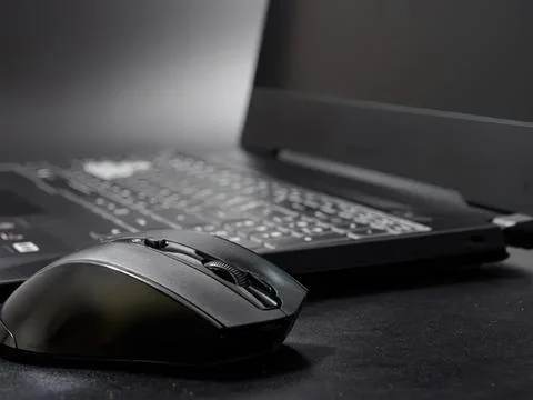 Computer mouse and laptop on desk for work or study 写真素材