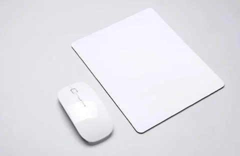 Computer mouse and mouse pad on a clean white desk Stock Photos