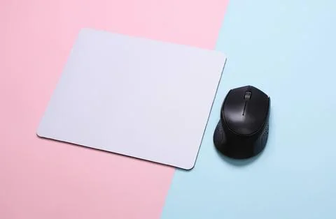 Computer mouse and mouse pad on pastel background Stock Photos