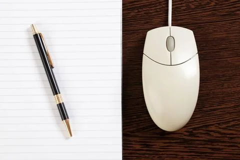 Computer mouse and pen with paper the computer mouse and pen with paper Co... Stock Photos