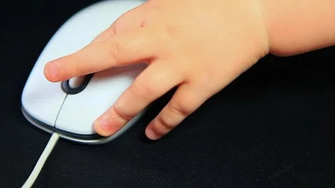 Computer mouse baby hand dark background Stock Footage 262531936