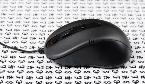 Computer mouse on a background of signs of money 스톡 사진