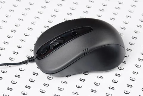 Computer mouse on a background of signs of money 스톡 사진