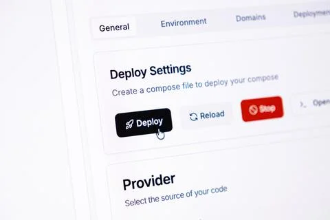 A computer mouse cursor hovers over a deploy button on a web development 写真素材