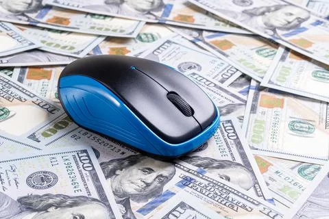 Computer mouse on dollars background Fotos de archivo