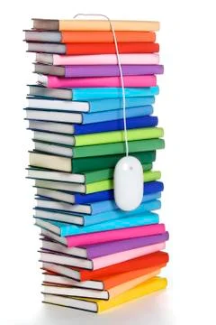 Computer mouse hanging from top of rainbow-colored book stack 스톡 사진