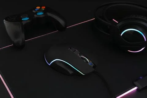 Computer mouse, headset and game controller on black background, closeup Stock Photos