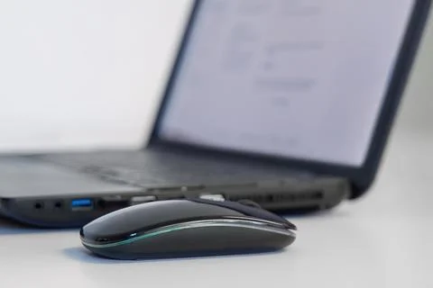 Computer mouse with laptop on white office desk workspace Stock Photos