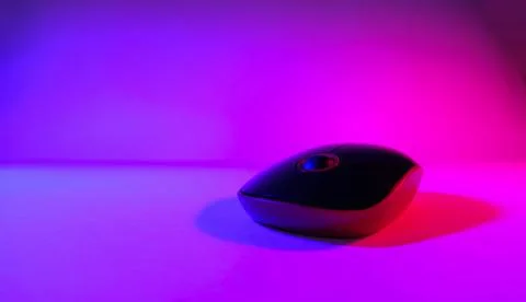 Computer mouse in neon light, ultraviolet light, photo taken in a photo studi Stock Photos
