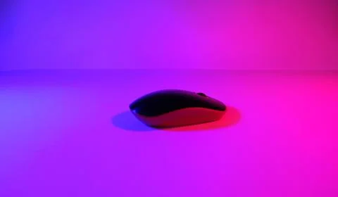 Computer mouse in neon light, ultraviolet light, photo taken in a photo studi Stock Photos