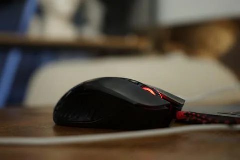 Computer mouse next to laptop Stock Photos