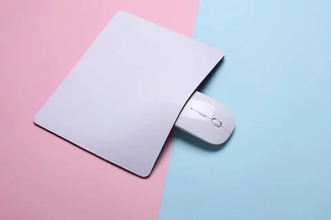 Computer mouse with a paper cover on pink and blue background Stock Photos