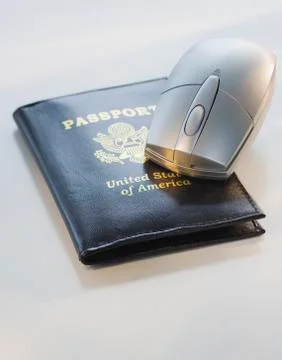 Computer mouse on passport Foto stock