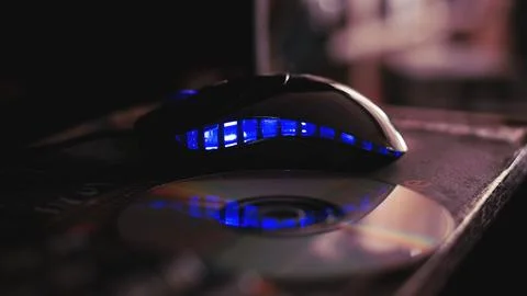 A computer mouse with reflective blue led lighting. Stock Photos