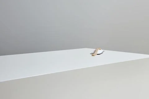 A computer mouse rests on a white, rectangular surface. Covered with a slic.. Stock Photos