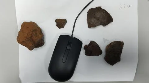 Computer Mouse with Rocks on Paper for Size Comparison Stock Photos